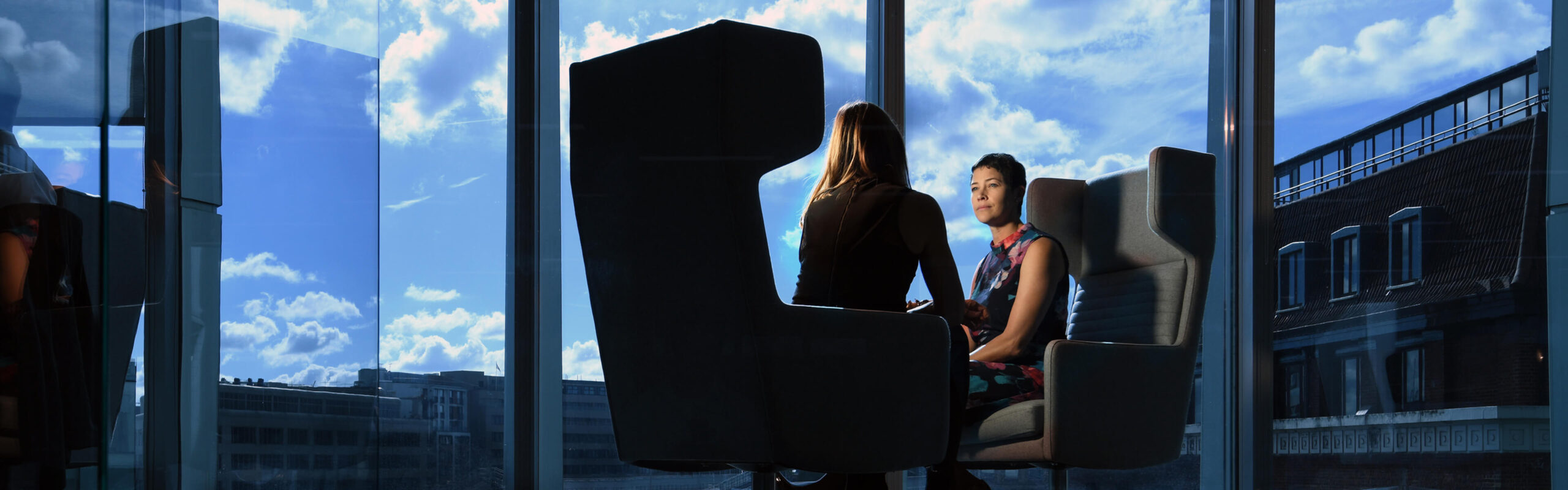 Two women sitting in an office.